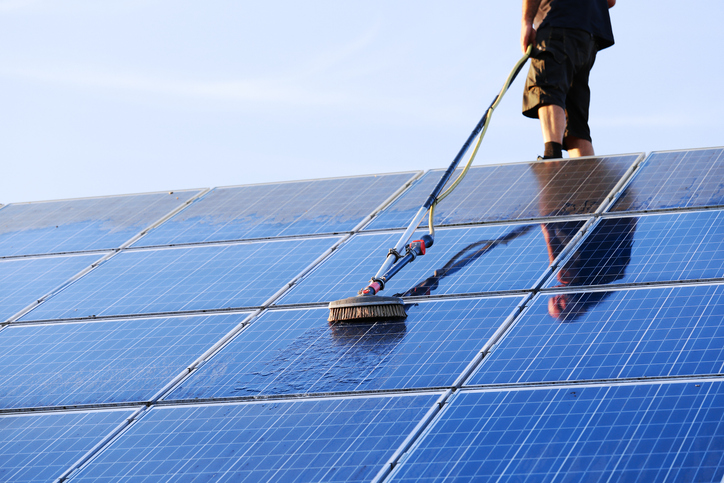 A worker cleaning solar panels of dust and pollen in Tipperary